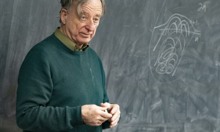 Matematikern Dennis Sullivan framför en svart tavla.